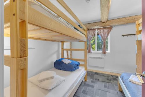 a room with two bunk beds and a window at HI Nordegg - Hostel in Nordegg
