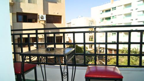 a balcony with a table and two chairs at Hotel Nouzha in Fès