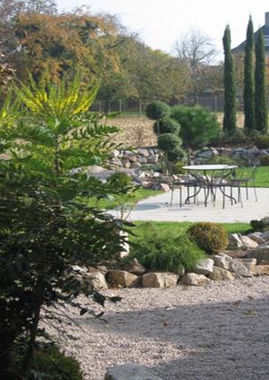 a park with a picnic table and a tree at Hôtel Restaurant Oberlé in Kilstett