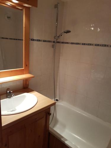 a bathroom with a sink and a shower and a tub at Les Menuires sur les pistes in Les Menuires