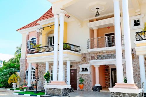 a large white house with columns at 5 Star Villa Hotel in Accra