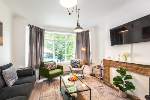 a living room with a couch and a fireplace at KGV Stays - Serenity House 3 bedroom near to the hospital with parking in Southampton