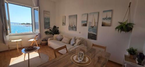 a living room with a couch and a table at Beach Side Holiday in Omiš