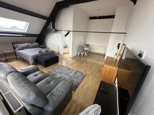a living room with a couch and a bed at The Church M in Manchester
