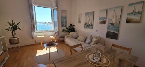 a living room with a couch and a table at Beach Side Holiday in Omiš