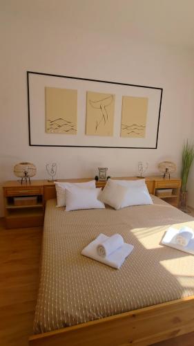 a bedroom with a bed with two towels on it at Beach Side Holiday in Omiš