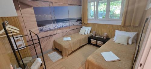 a small room with two beds and a window at Beach Side Holiday in Omiš