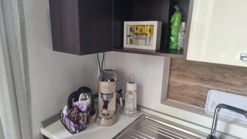 a kitchen counter with a coffeemaker on top of it at Casa Piazza Santa Maria in Isernia