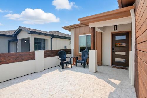 a patio with two chairs and a table at Brand New Cool Comfy Lawrence Retreat Duplex in Lawrence