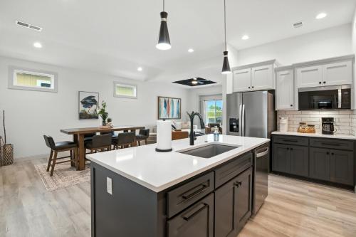 a kitchen with a sink and a dining room at Brand New Cool Comfy Lawrence Retreat Duplex in Lawrence