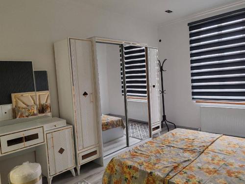 a bedroom with two beds and a dresser and a mirror at Snowlight Studio in Toshkent-Passajir Bekati
