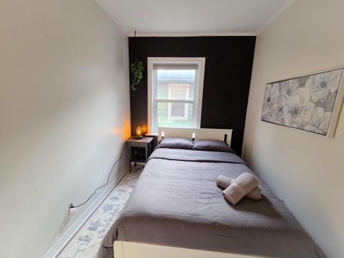 a bedroom with a bed with a stuffed animal on it at Byward Market Downtown Guesthouse in Ottawa