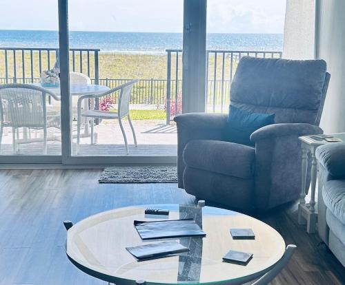 a living room with a couch and a table at The Seahorse, a 2bed beach paradise in Fernandina Beach, swimming pool! in Fernandina Beach