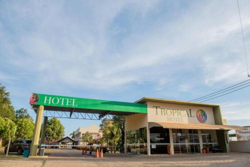 a hotel sign in front of a gas station at Hotel Tropical Garden in Primavera do Leste