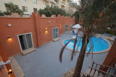 an overhead view of a swimming pool with a palm tree at Settle Inn Mirage Boutique Hotel in Cairo