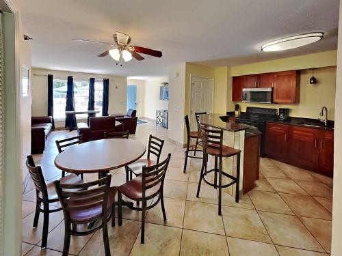 a kitchen and living room with a table and chairs at Put-in-Bay Poolview Condo #3 in Put-in-Bay