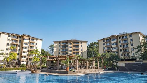 an image of a swimming pool with apartment buildings in the background at Costa Linda Amazing 1-03! in Jacó