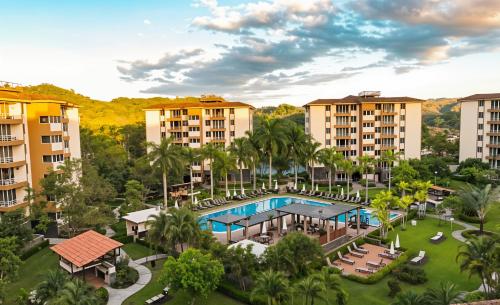 an aerial view of a resort with a pool and palm trees at Costa Linda Amazing 1-03! in Jacó