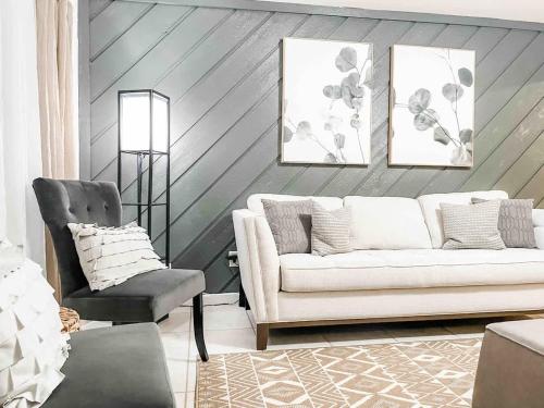 a living room with a couch and a chair at Serene Private Two Bedroom Townhouse in East TLH in Perkins