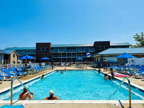 a pool at a hotel with people playing in it at Put-in-Bay Poolview Condo #3 in Put-in-Bay