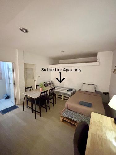a bedroom with a bed and a table and chairs at La Locanda in Bangkok