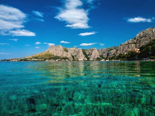 a view of the water with mountains in the background at Beach Side Holiday in Omiš