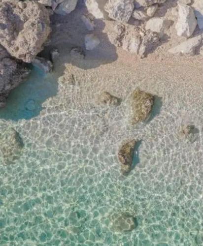 an aerial view of a beach with rocks in the water at Beach Side Holiday in Omiš