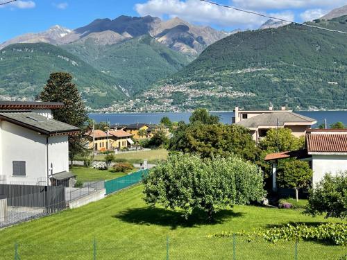 a house with a yard with mountains in the background at Como Lake Home in Colico