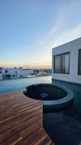a house with a swimming pool on a wooden deck at Luxury condo whit ocean view in Altra Beach in Playa del Carmen
