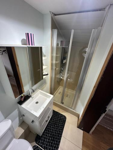 a bathroom with a white sink and a shower at The Church V in Manchester