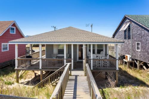 a home with a deck and a house at 5050 - Sea Haven in Kill Devil Hills