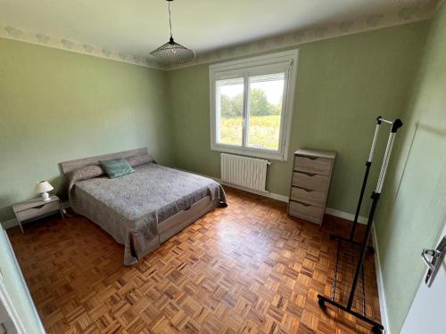 a bedroom with a bed and a window at Maison BERDOT in Sévignac-Thèze