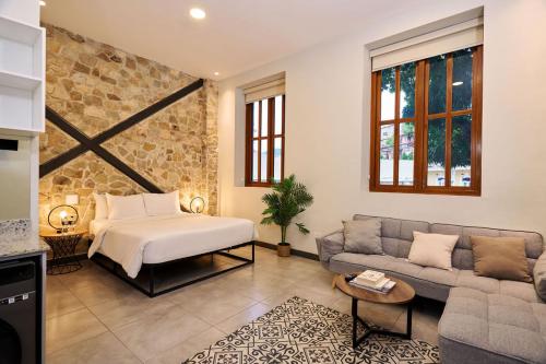 a living room with a bed and a couch at AmazINN Places Casa Fortaleza in Panama City