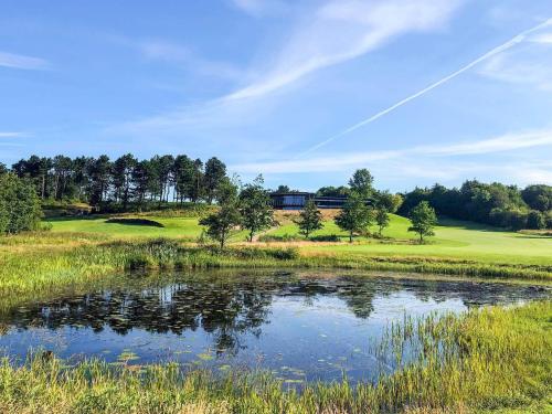 a view of a golf course with a pond at 6 person holiday home in Vemb-By Traum in Vemb