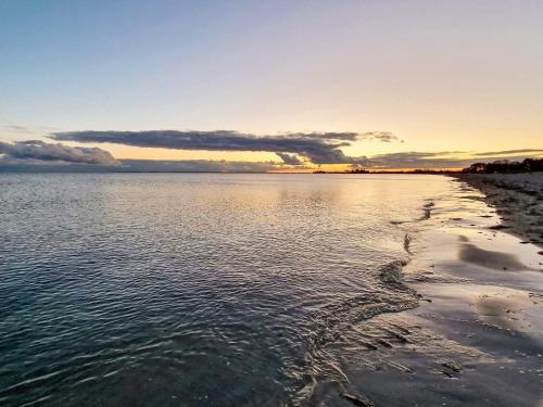 a view of a body of water at sunset at 6 person holiday home in Sydals-By Traum in Neder Lysabild
