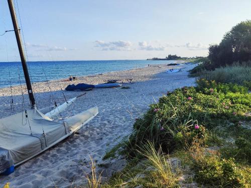 a beach with a boat laying on the sand at 6 person holiday home in Sydals-By Traum in Neder Lysabild