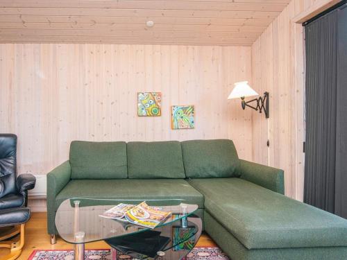 a living room with a green couch and a glass table at Seaside Escape in Ho Bay - By Traum Ferienwohnungen in Ho