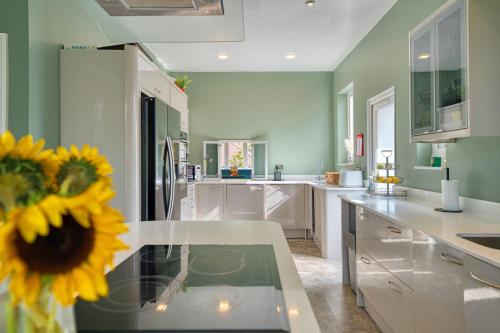 a kitchen with a table with a sunflower on it at Group Stay 5BR Home with Parking Sleeps 9 In Giffnock in Giffnock