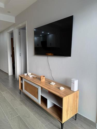 a living room with a television on a wall at Coral Cove in Flic-en-Flac
