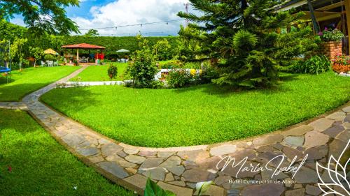 a garden with a stone walkway in a yard at Hotel María Isabel Ataco in Concepción de Ataco