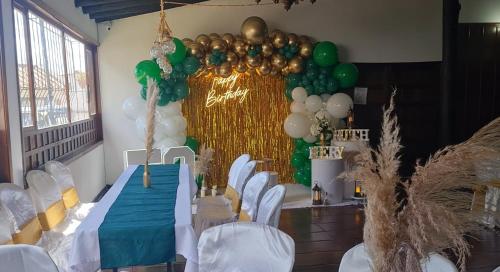 a room with a table with green and white balloons at Hotel MAXIRUMA - Villa TAMAUKA in Iza