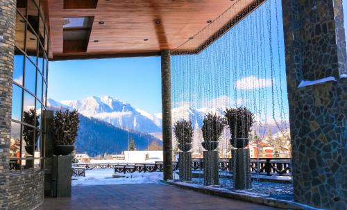 a view of the mountains from a building with cactus at Lux Garden Hotel in Azuga