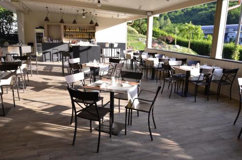 a restaurant with tables and chairs on a patio at EcoHotel Ristorante Milano in Borgo a Mozzano