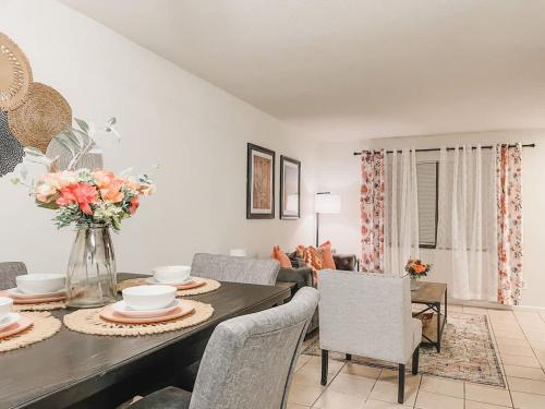 a living room with a dining room table with chairs at Affordable Retro Retreat 80s Townhome in Perkins