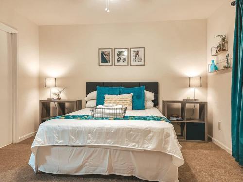 a bedroom with a large bed with blue pillows at Affordable Retro Retreat 80s Townhome in Perkins