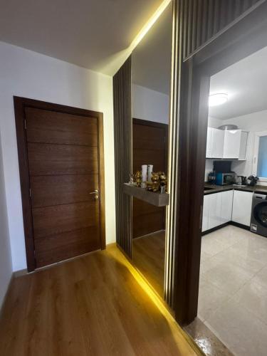 a hallway with a wooden door in a kitchen at Apartment with garden inside Kian Grand Heights Compound in 6th Of October