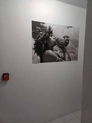 a black and white photo of a woman on a wall at "Frangipani" city center room in Papeete