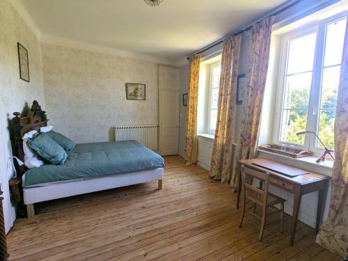 a bedroom with a bed and a desk and windows at Gîte élégant au Château d'Euvezin avec jardin et parking privatif - FR-1-584-383 in Euvezin