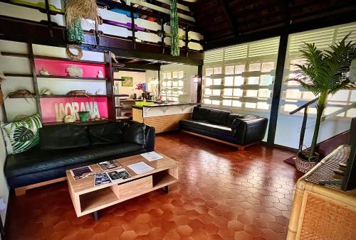 a living room with a couch and a coffee table at Linareva Moorea Beach Resort in Haapiti