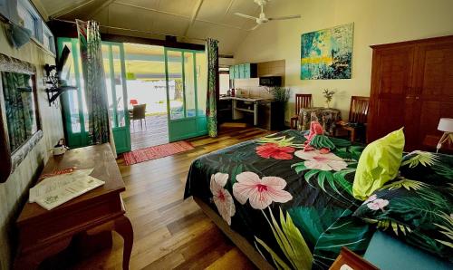 a bedroom with a bed with flowers on it at Linareva Moorea Beach Resort in Haapiti